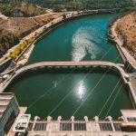 disparo-vertical-de-un-rio-junto-las-carreteras-de-la-ciudad-bajo-un-cielo-azul-claro (1) (1)